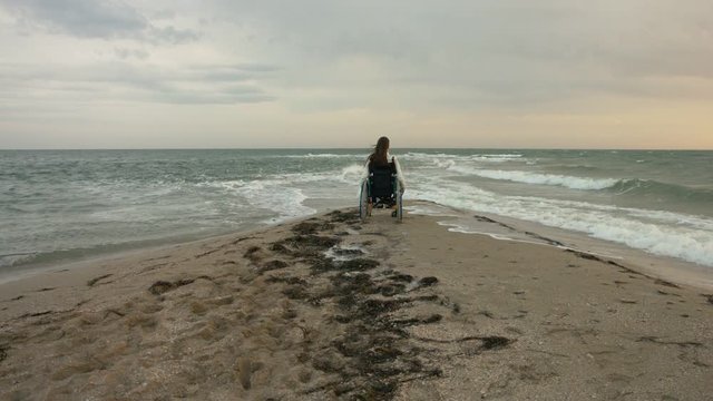 The disabled person meets the sun on the sea
