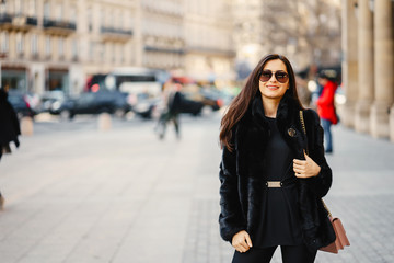 stylish girl walking through Paris