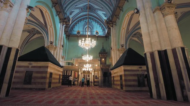 Hebron, Al Khalil, Palestine, West Bank. Wide shot, dolly right inside the Ibrahimi Mosque, Al Haram Al Ibrahimi, The Cave of the Patriarchs, Tomb of Isaac on right and his wife on left. 4K footage