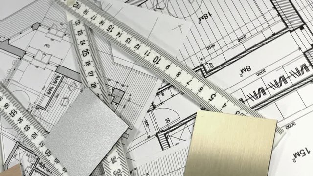 Blueprints: architectural drawings, yardstick - folding ruler & samples of modern interior decoration materials - decorative plastics smoothly rotate on the surface of the architectural plan
