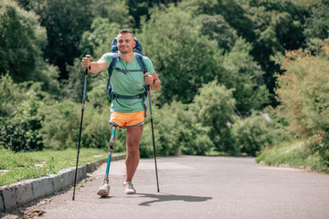 Positive man leading a healthy life while having a prothesis