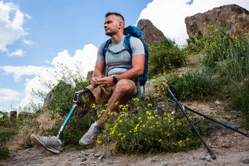 Thoughtful man with prosthesis resting in harmony with nature