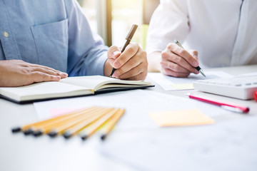 Tutor books with friends, Man sitting pointing studying together at desk with classmates exams, hands with books or textbooks writing to notebooks, learning, education and school concept