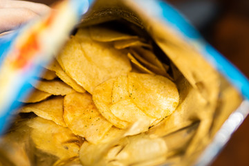 Sour cream and onion flavored potato chips in bag