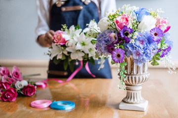 Arranging artificial flowers vest decoration at home, Young woman florist work making organizing diy artificial flower, craft and hand made concept
