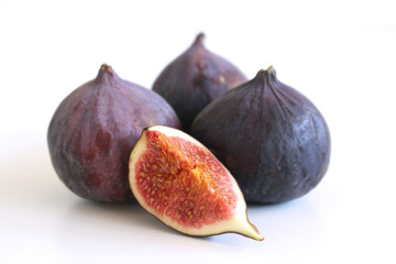 Juicy tasty figs on the white wooden background. Free space for text. Food concept.