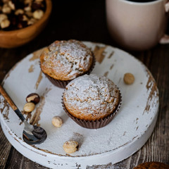 Homemade muffins decorated with sugar powder, hazel nuts