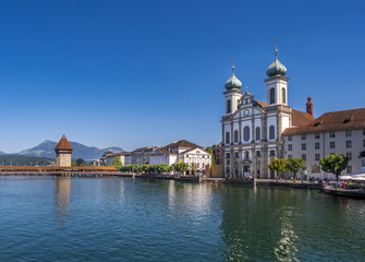 Fototapeta na wymiar Jesuit Church and Chapel Bridge on the River Reuss in Lucerne, Switzerland