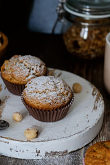 Homemade muffins decorated with sugar powder, hazel nuts