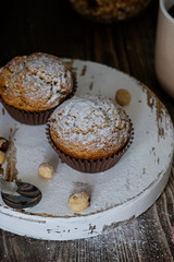Homemade muffins decorated with sugar powder, hazel nuts