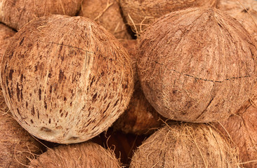 peeled coconuts on an even surface, stacked in bulk, completely filling the frame on an isolated background on an even surface, stacked in bulk, completely filling the frame