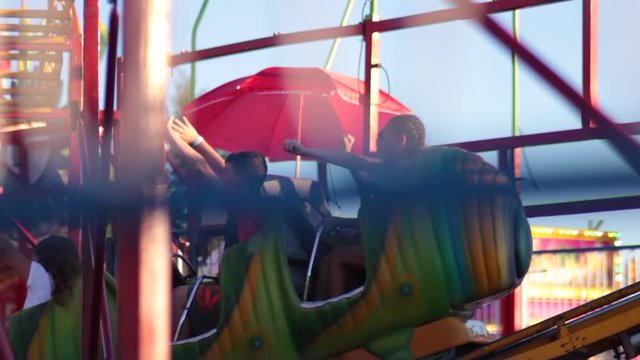 Close up kids zooming past in rollercoster carnival