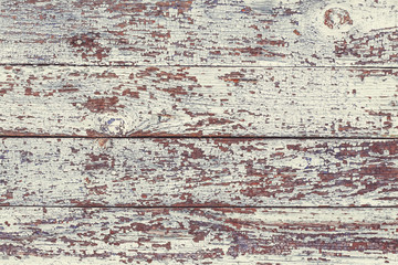 Old gray shabby wooden planks with cracked color paint