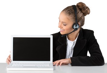 Beautiful young businesswoman with headset showing a laptop