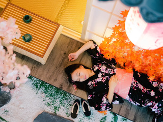 Aerial view Portrait of attractive asian woman wearing traditional Japanese Kimono, laying on floor...