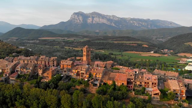 Ainsa, Spain. Flying over Ainsa village in Aragon mountains. Aerial view, UHD