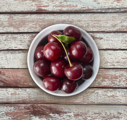 Cherry fruit. Cherries with copy space for text. Top view. Background of cherries. Ripe and tasty cherries on a wooden background.