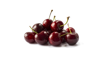 Fresh red cherries lay on white isolated background. Ripe cherry on a white background. Cherries with copy space for text.