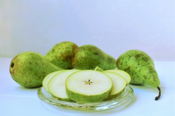 Conference pear,  variety of pear, sliced and whole, top copy space.