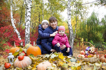 Happy family, mom with children in autumn park