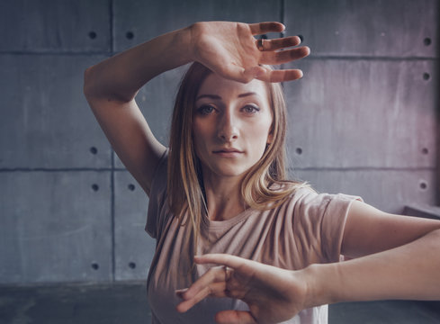 young beautiful woman professional dancer dancing during a rehearsal in a dance studio, modern dramatic style, experimental dance