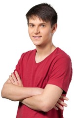 Young man smiling with his arms crossed