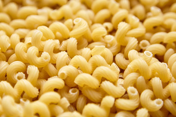 Heap of Uncooked Cavatappi Italian Pasta . Closeup, selective focus