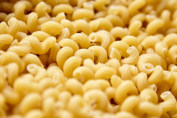 Heap of Uncooked Cavatappi Italian Pasta . Closeup, selective focus