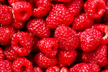 Heap of red ripe raspberries. Food background