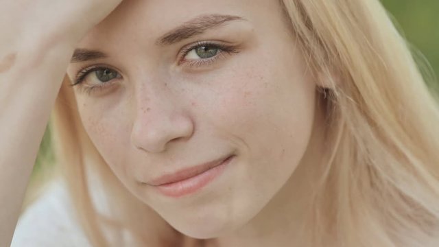 Close-up face of a smiling 19 year old blonde girl.