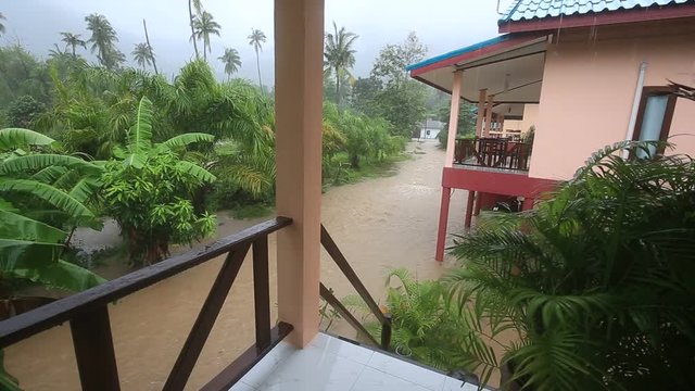 Flooding and tropical rain on the street in island Koh Phangan, Thailand. Natural disaster