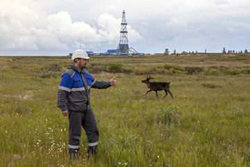 Engineer - technologist in special protective clothing on the background of the oil and gas...