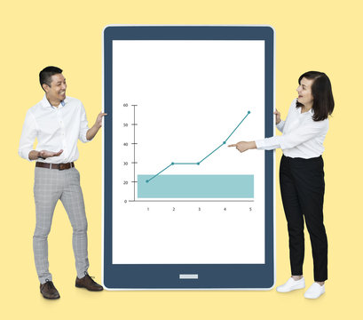 Cheerful diverse people showing a graph on a tablet - Powered by Adobe