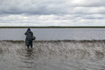 Fisherman on a lake with spinning