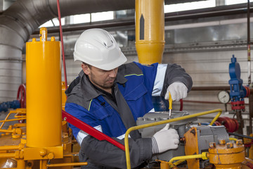 The mechanic - the repairman , operator production gas, Oil, gas industry. gas conditioning...