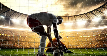 Intense soccer moment in front of the goal on the professional soccer stadium.