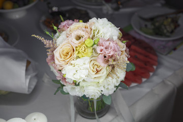 Delicate wedding bouquet of flowers on a festive table