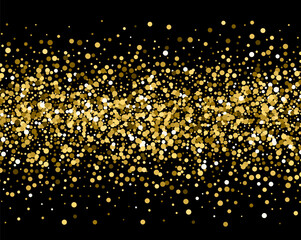 Gold sparkles on black background. Gold glitter .