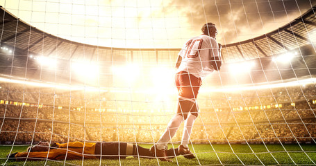 Intense soccer moment in front of the goal on the professional soccer stadium.