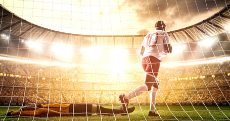 Intense soccer moment in front of the goal on the professional soccer stadium.