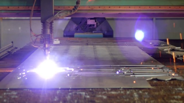 Plasma cutting of metal on a modern laser machine, close-up, production of plasma metal cutting, working