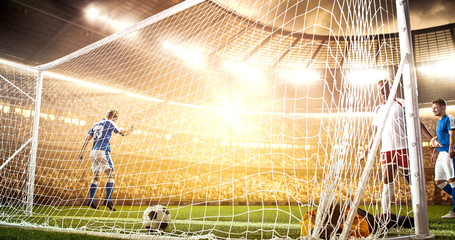 Intense soccer moment in front of the goal on the professional soccer stadium.