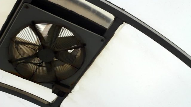 A industrial size ceiling fan pan left.