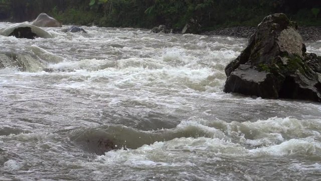 Water cascading over boulders in slow motion. On Rio Abanico on the Amazonian slopes of the Andes, Morona Santiago province, Ecuador