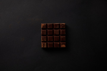 top view of gourmet sweet chocolate on black background