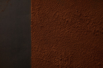 top view of delicious brown cocoa powder on black background