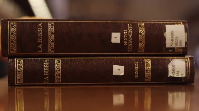 hands stacking books