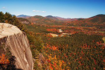 View from the mountain to autumn forests and mountains. White Mountain National Forest.  USA.
