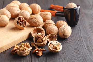 Walnuts and nutcracker on wood