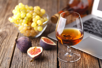 glass of cognac with fruit on the table